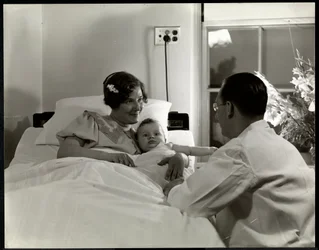 A mother and child in a hospital bed, New York, c.1937